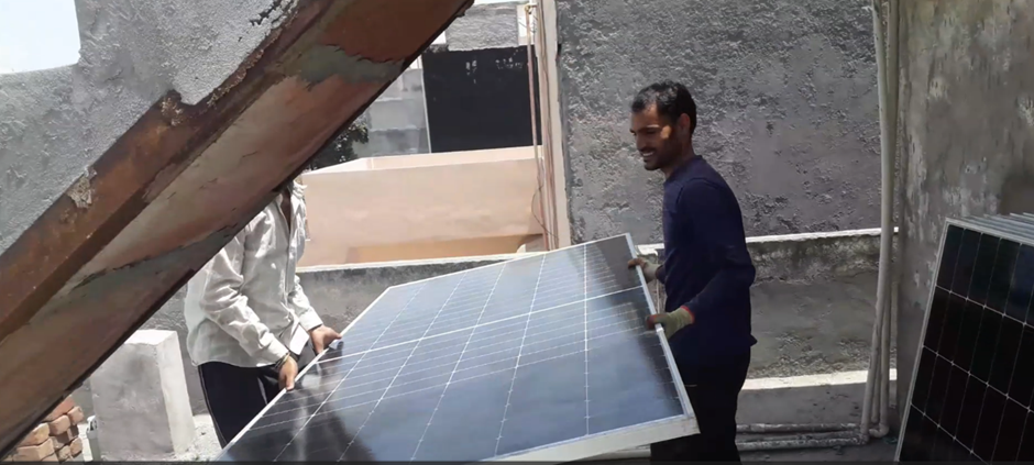 The picture shows the handling of solar panels on the roof. Solar with Yash
